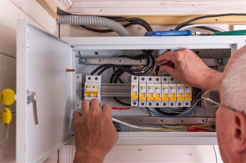A photograph of an electrical check being conducted in a house