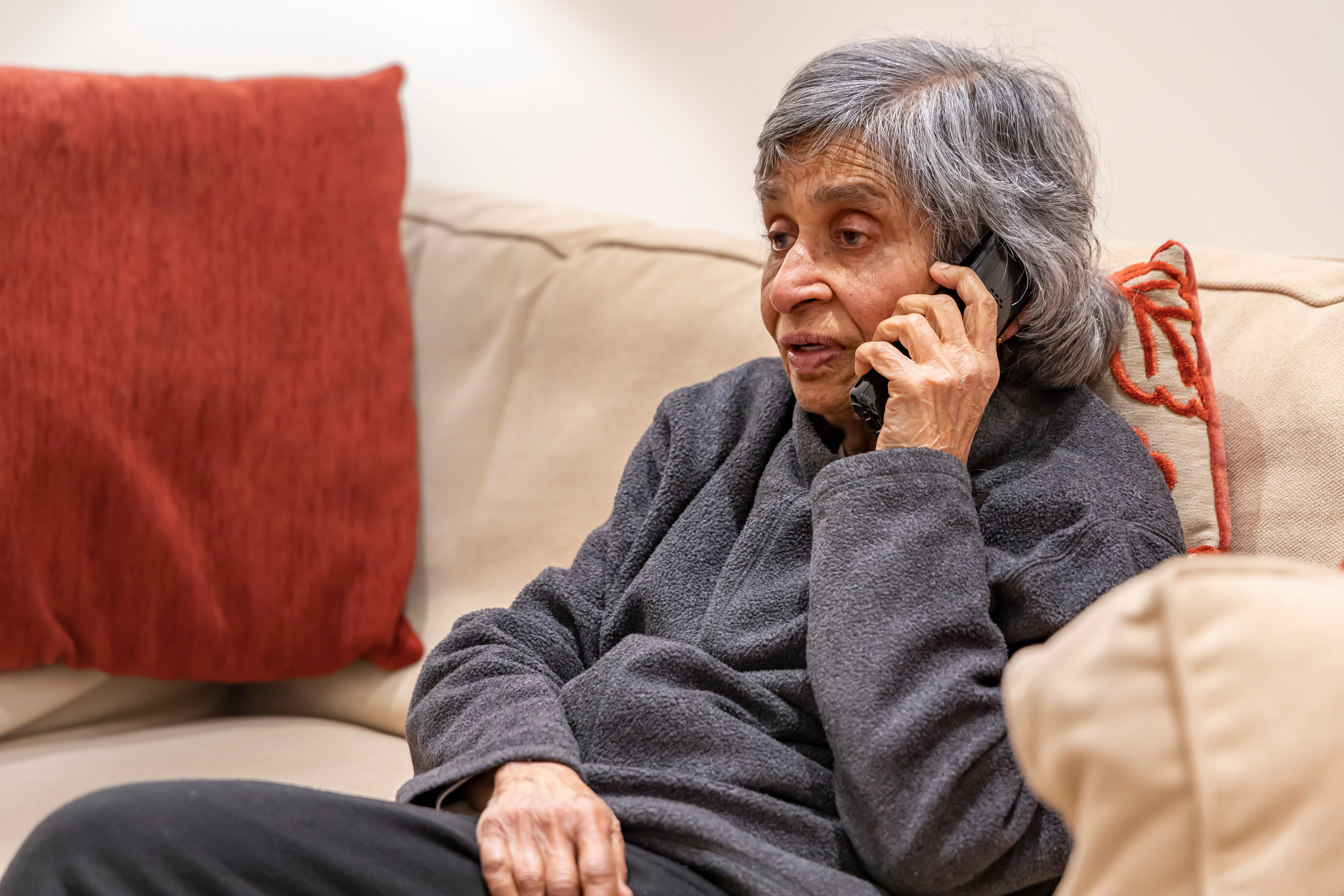 An old woman on the phone talking with the Council