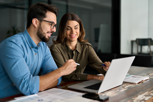 Housing officers discussing ideas around a computer